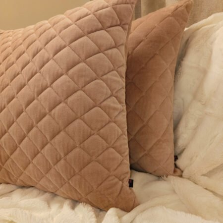 Plush peach cushion cover featuring diamond quilting pattern.